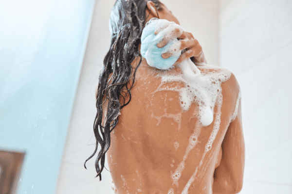 girl happily bathing with antibacterial body wash