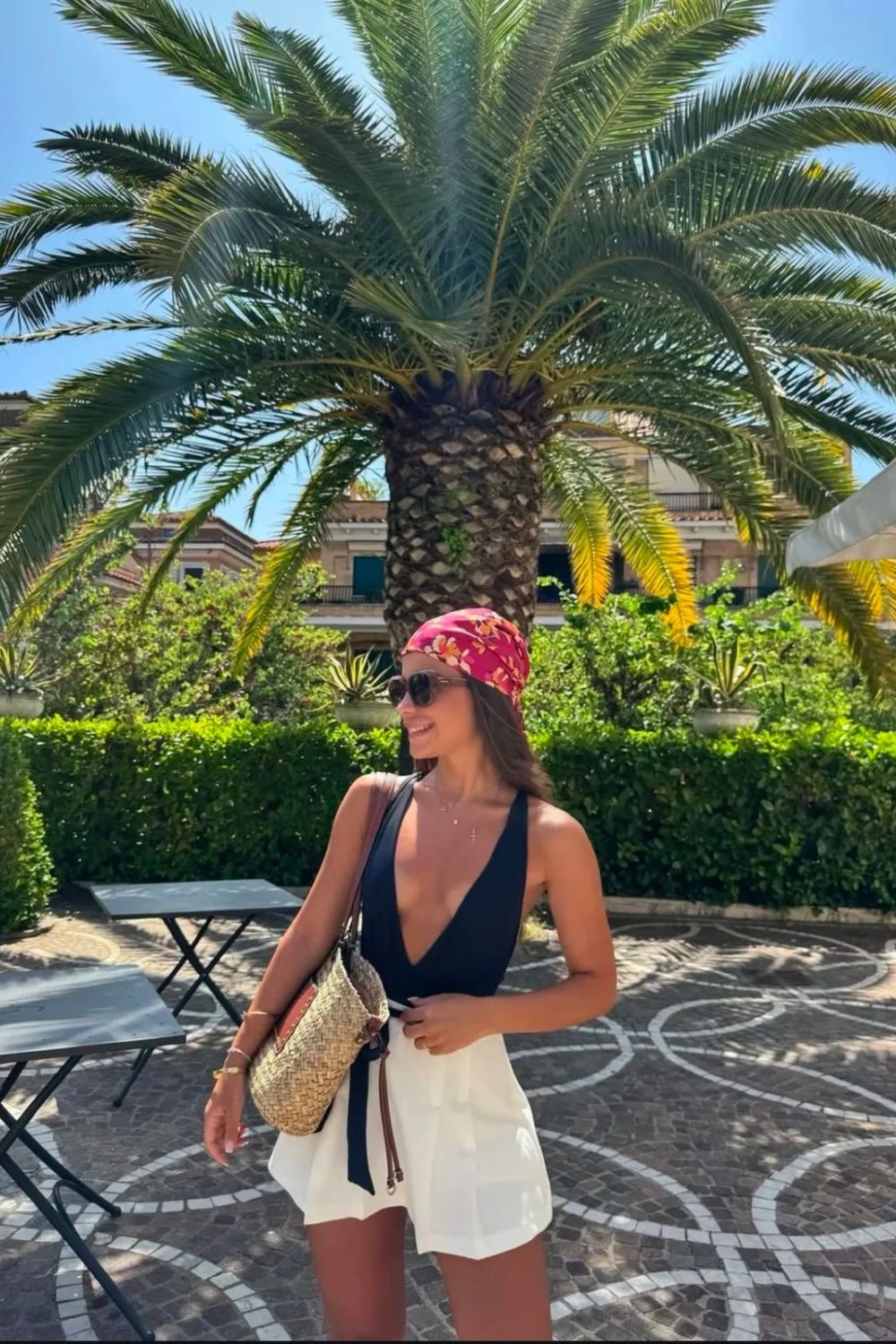 Deep-V bodysuit with white skort and floral headscarf