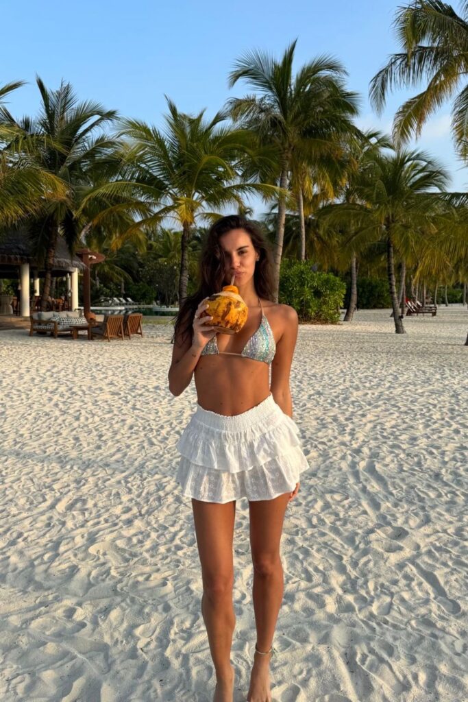 19 Chicest Beach Outfits That Belong in Your Summer Photo Dump iridescent sequin bikini & ruffled eyelet mini skirt