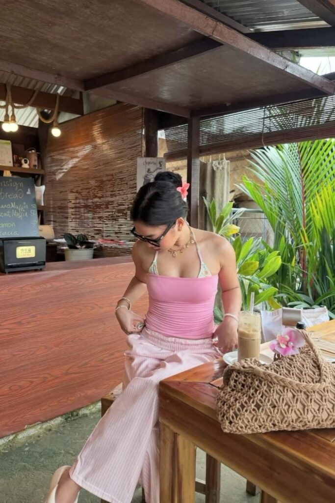 19 Chicest Beach Outfits That Belong in Your Summer Photo Dump pink tube top over pastel bikini